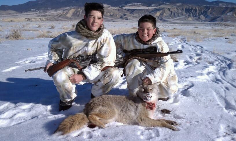Two hunters with a coyote taken on a Colorado winter predator hunt